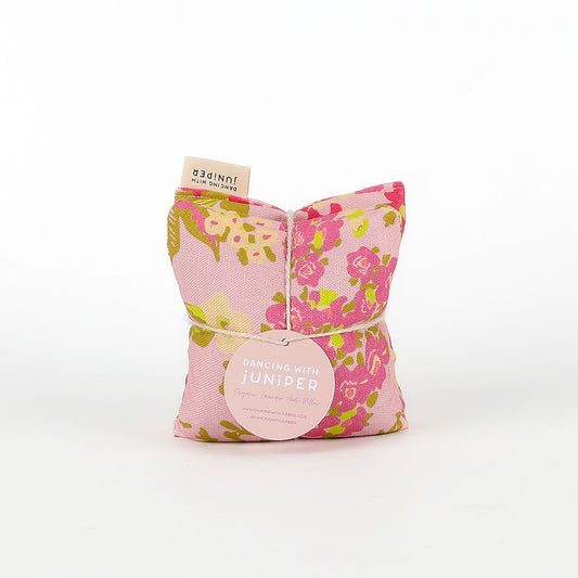 Floral-patterned heat pillow on a white background