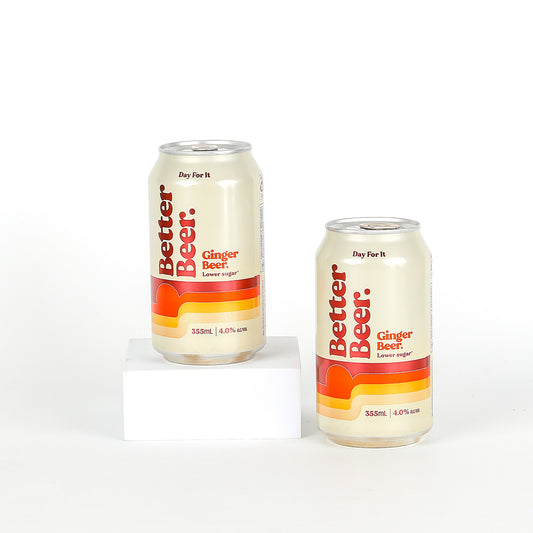 Two cans of Better Beer Ginger Beer on a white background