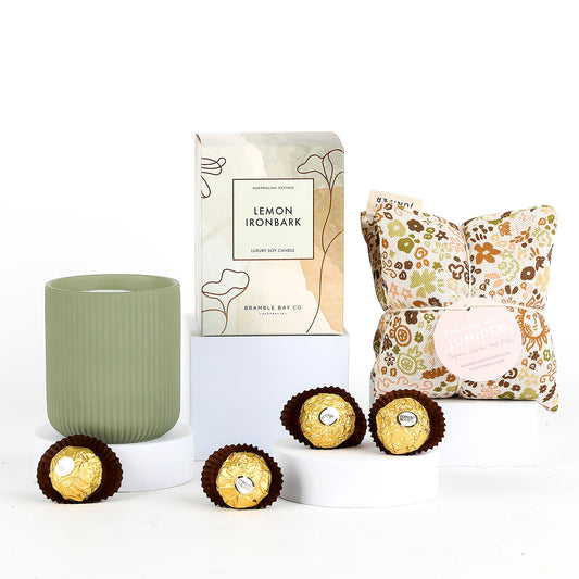 Candle & packaging, heat pillow and chocolates on a white background