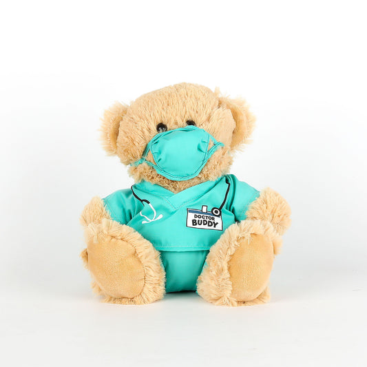 Teddy bear in a turquoise medical outfit with a mask on a white background