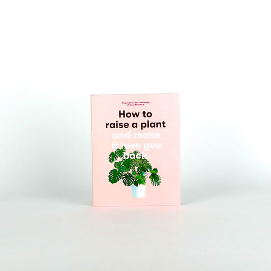 Book titled 'How to raise a plant and make it love you back' with a plant illustration on a white background