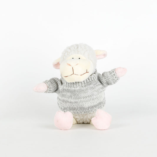Plush toy sheep with a knitted sweater on a white background