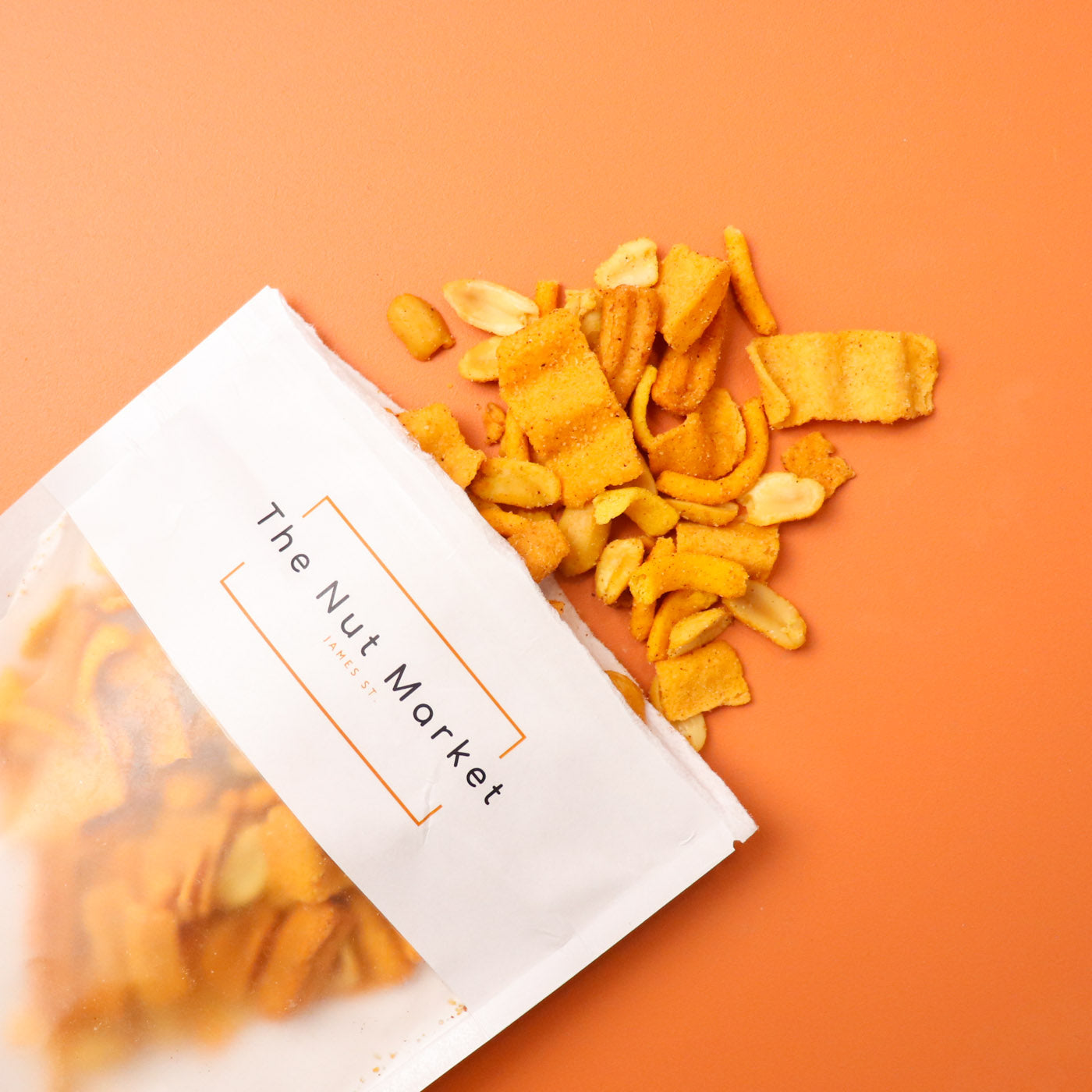 Packaged snack from The Nut Market on an orange background