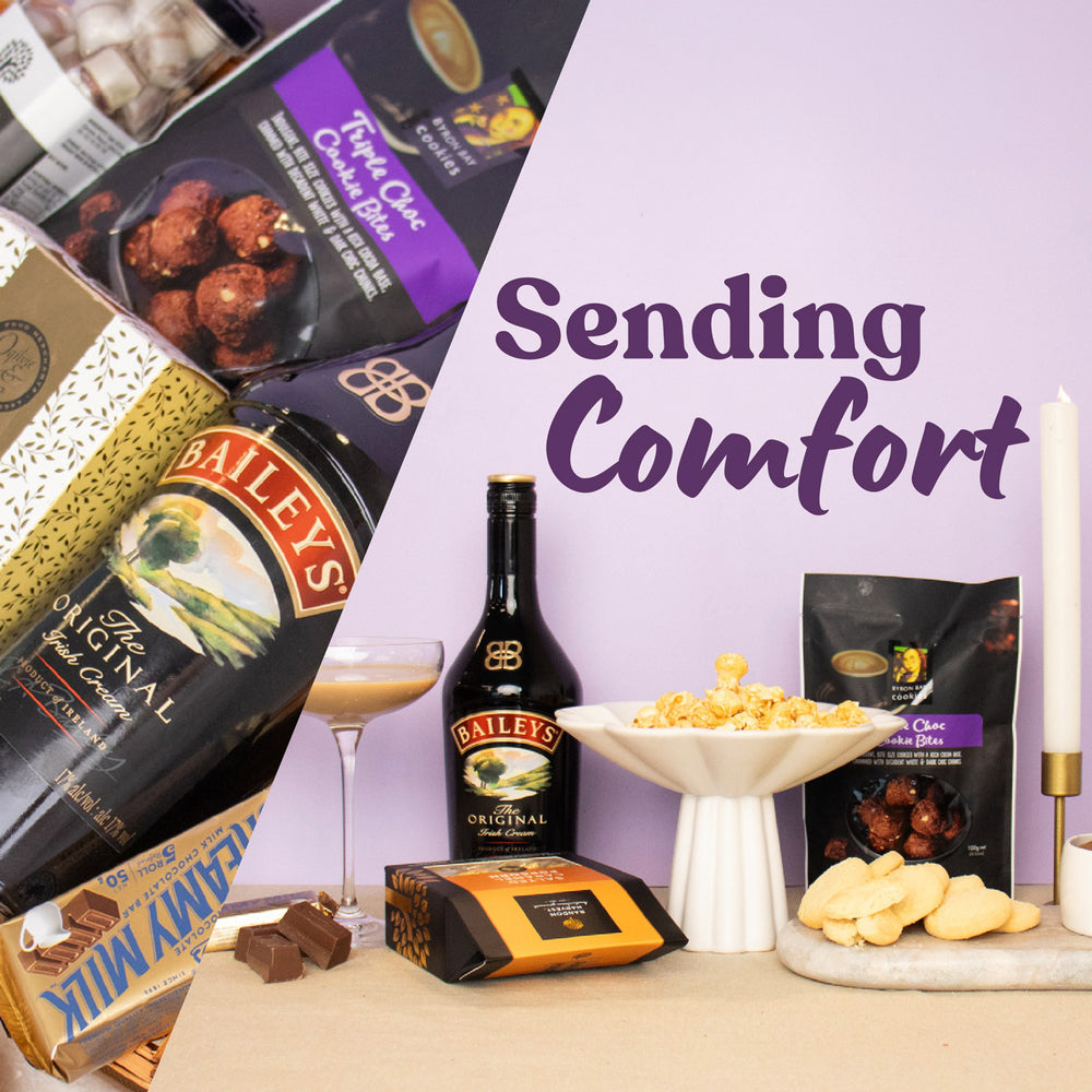 Gourmet gift set with Baileys, chocolates, and snacks on a table with 'Sending Comfort' text.