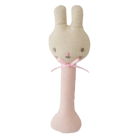 Textured bunny-shaped rattle with pink bow on a white background