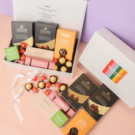 Assorted chocolate bars in a gift box with visible branding on a pastel background