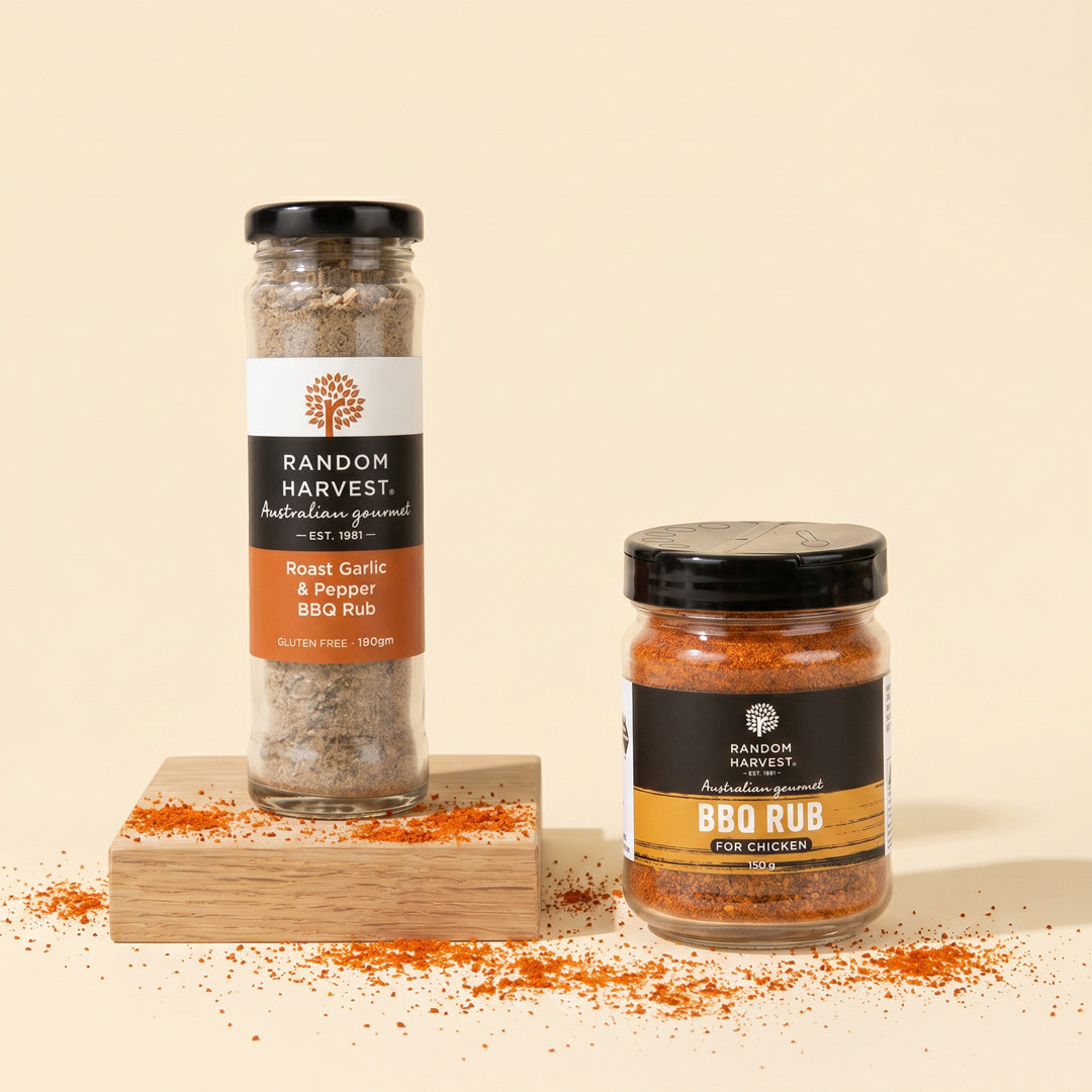 Two jars of Random Harvest BBQ Rub on a beige background