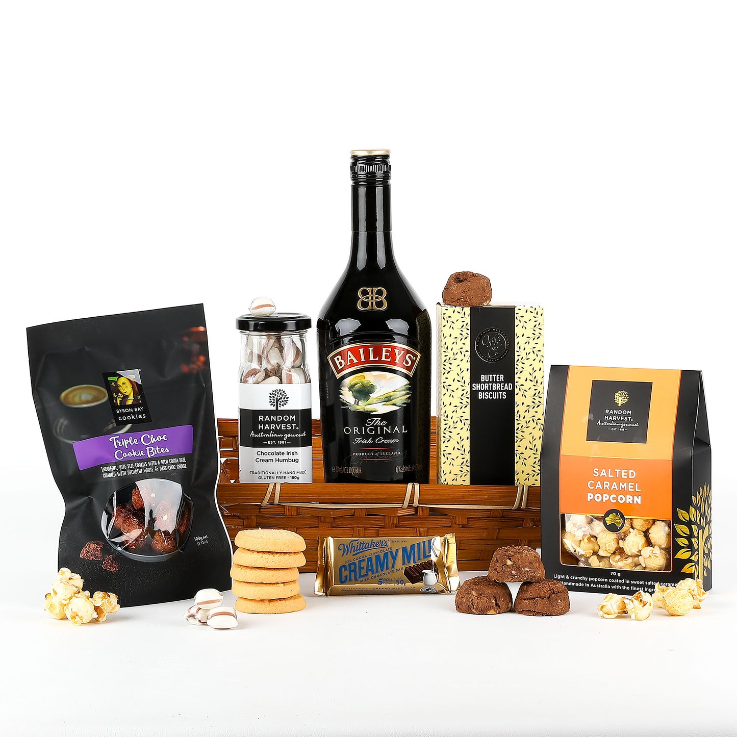 Gourmet gift basket with Bailey's Irish Cream, cookies, popcorn and other treats on a white background