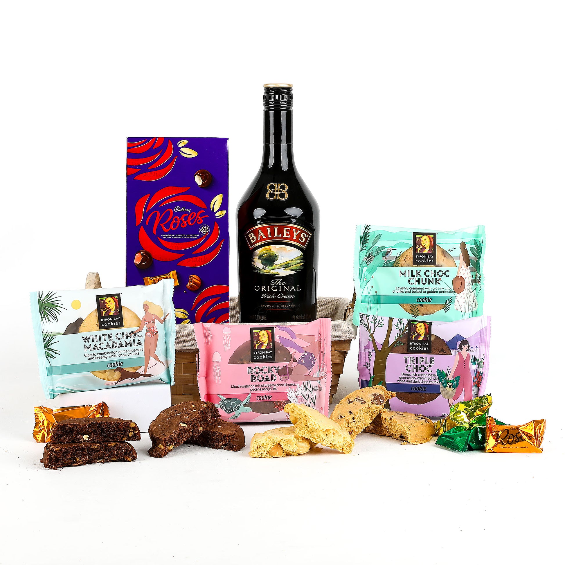 Assorted premium gourmet cookies, a bottle of Baileys and a box of Cadbury "Roses" chocolates on a white background