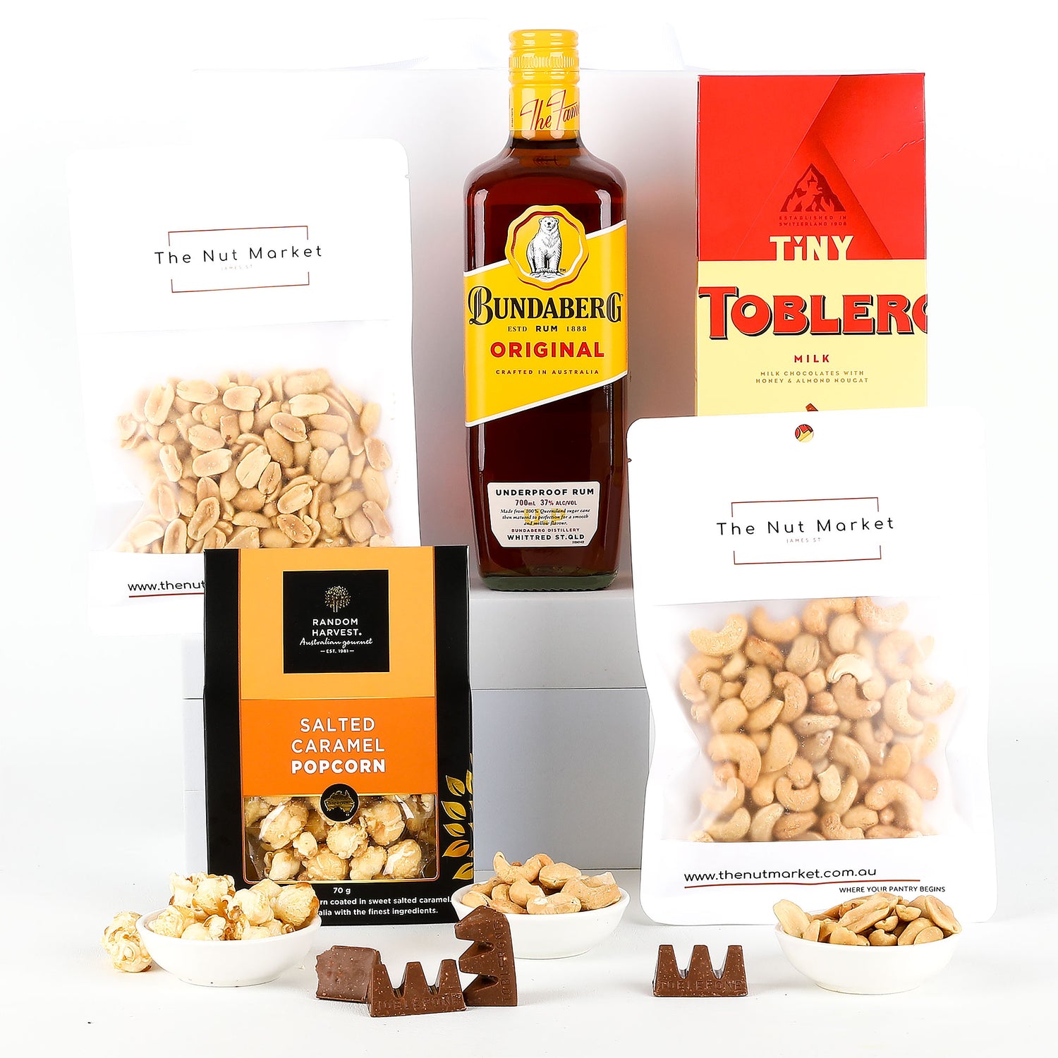 Assorted snacks and a bottle of Bundaberg Rum on a white background
