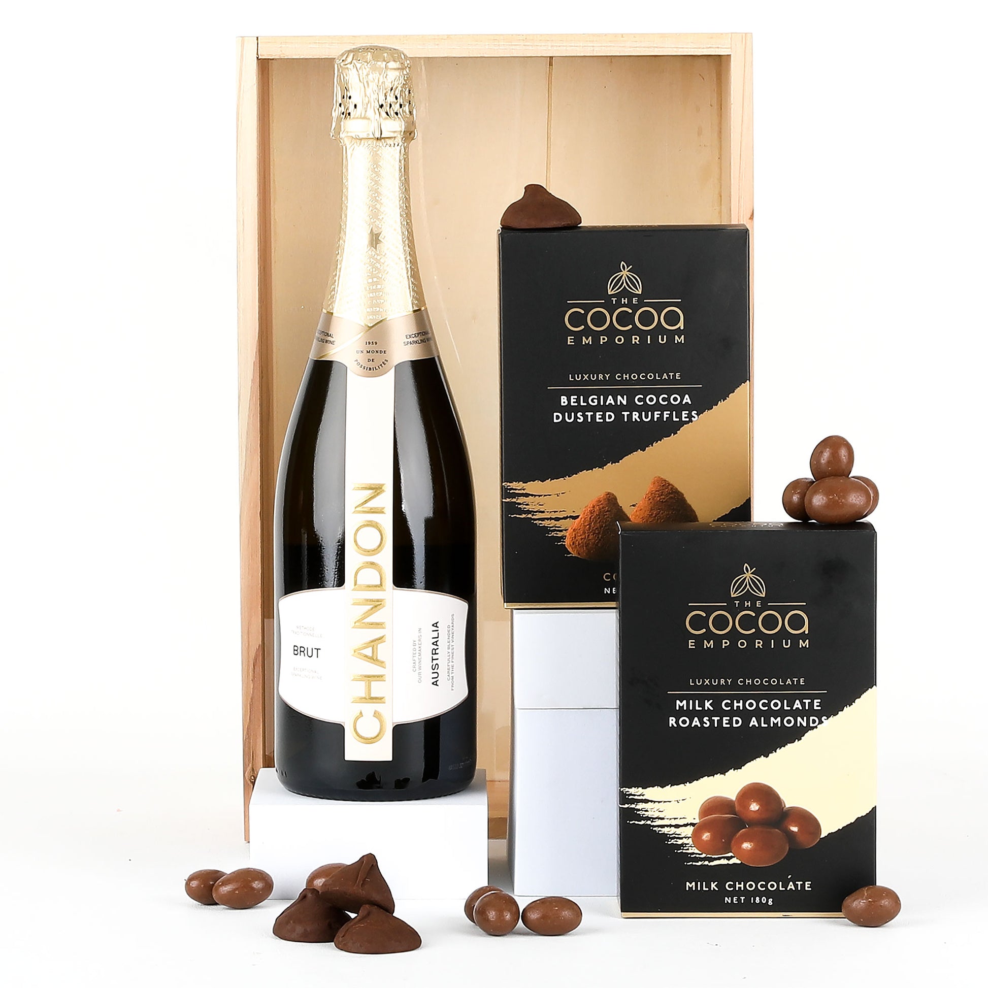 Bottle of Chandon champagne with Milk Chocolate Roasted Almonds and Belgian Cocoa Dusted Truffles in a wooden crate.