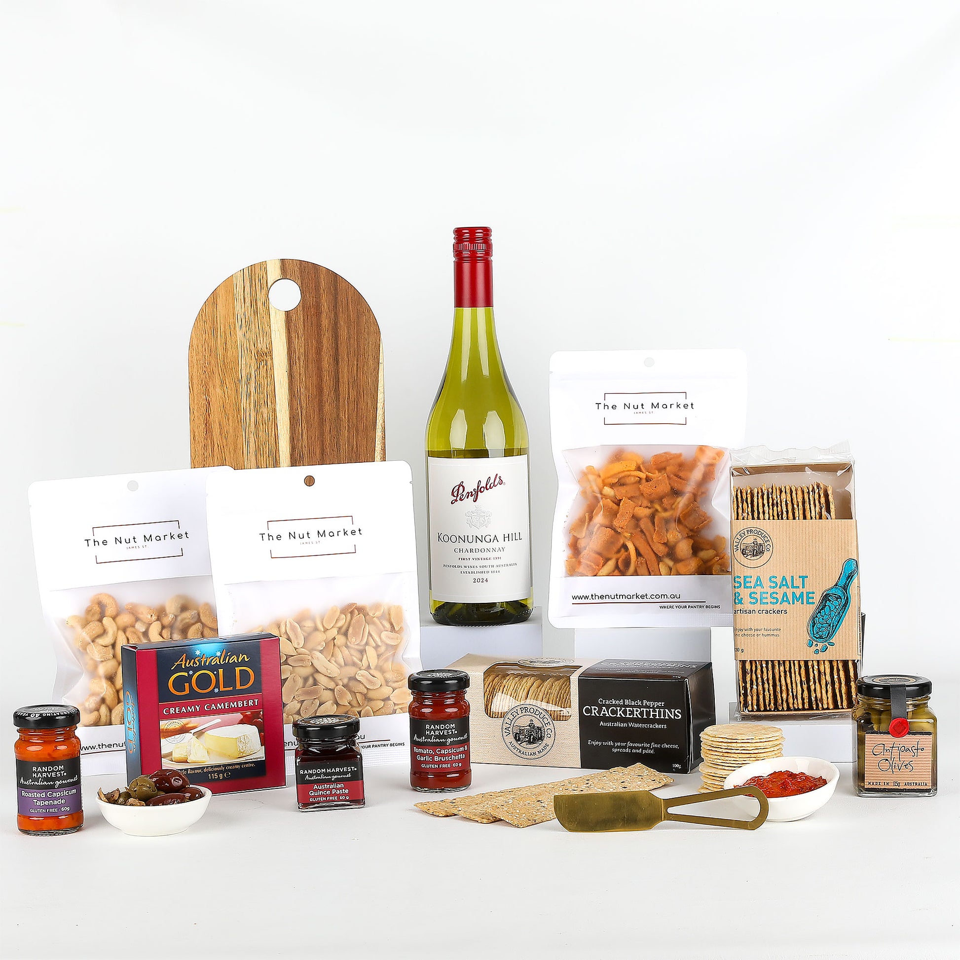 Assorted food items including wine, nuts, spreads & cheese board on a white background