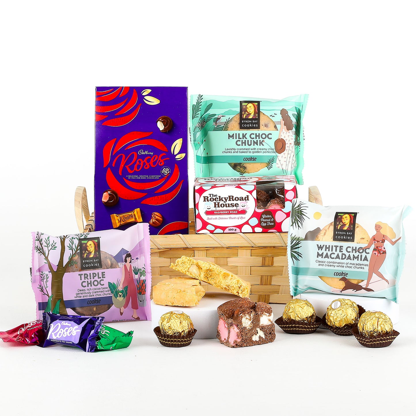 Assorted chocolate and confectionery items including Cadbury Roses, Lindt, and Rocky Road House on a white background.