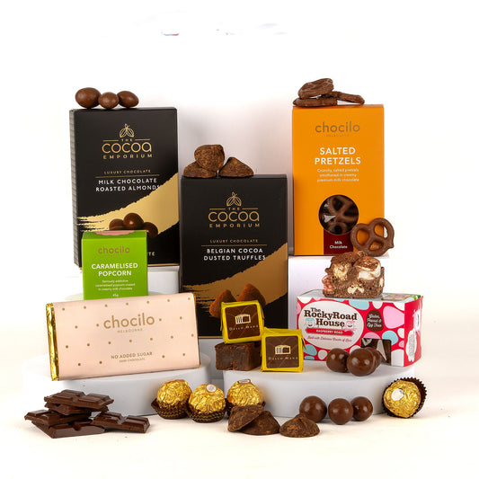 Assorted boxed chocolate products including roasted almonds, dusted truffles, salted pretzels and rocky road on a white background