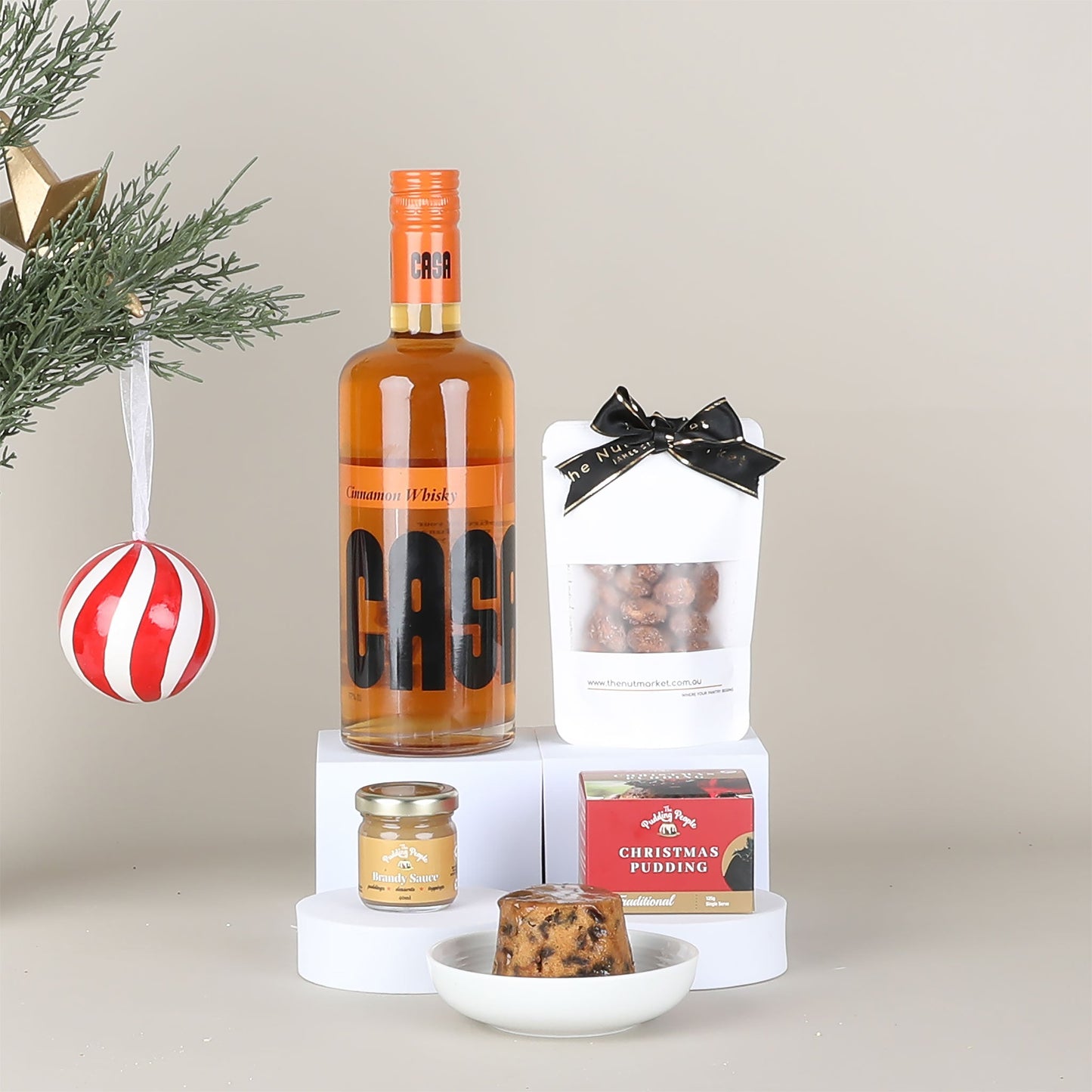 Bottle of CASA Cinnamon Whisky with Christmas-themed items.
