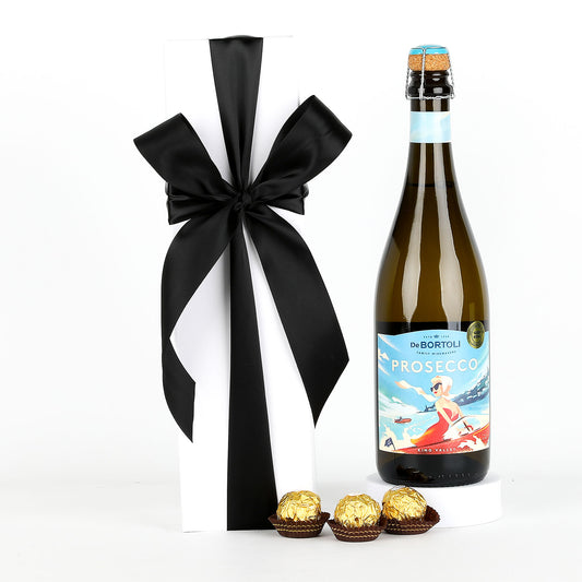 Bottle of De Bortoli Prosecco with a black ribbon and Ferrero Rocher chocolates on a white background