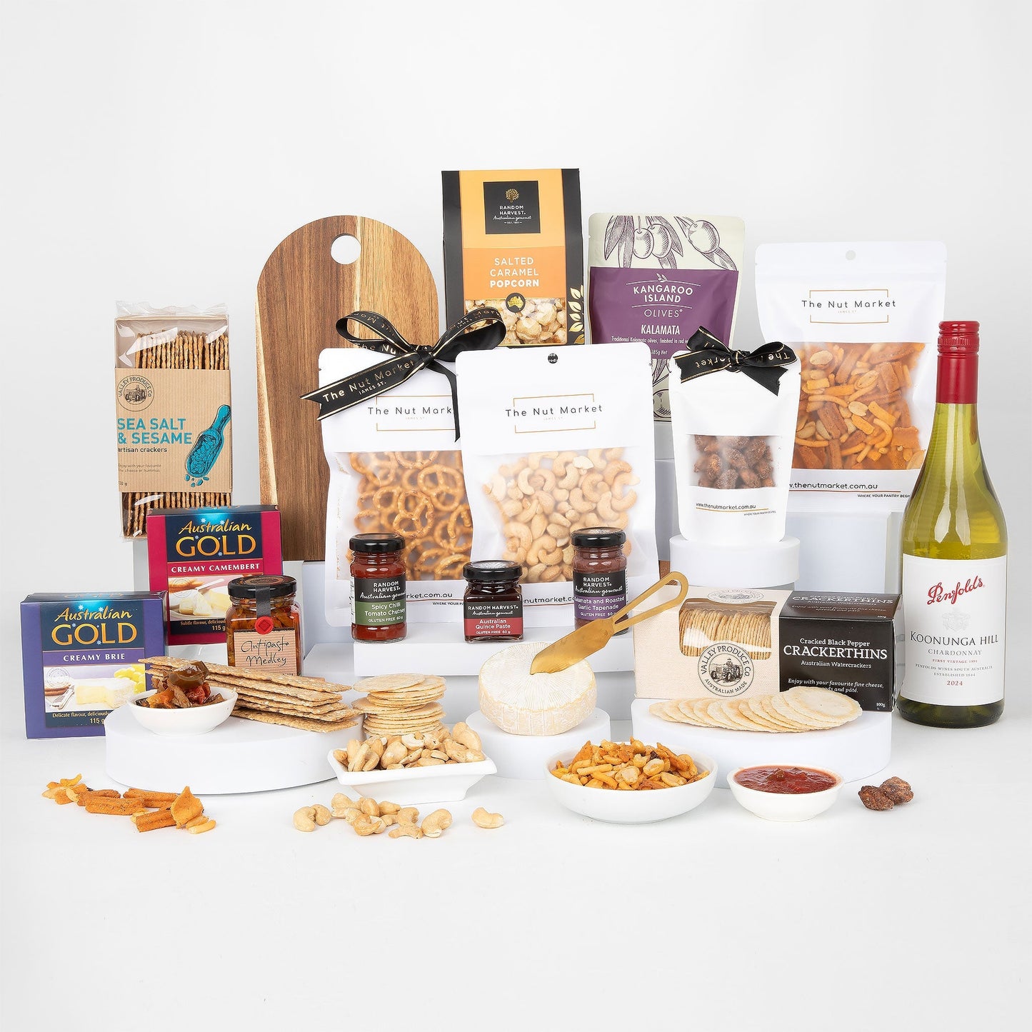 Assorted food items including nuts, crackers, and wine on a white background