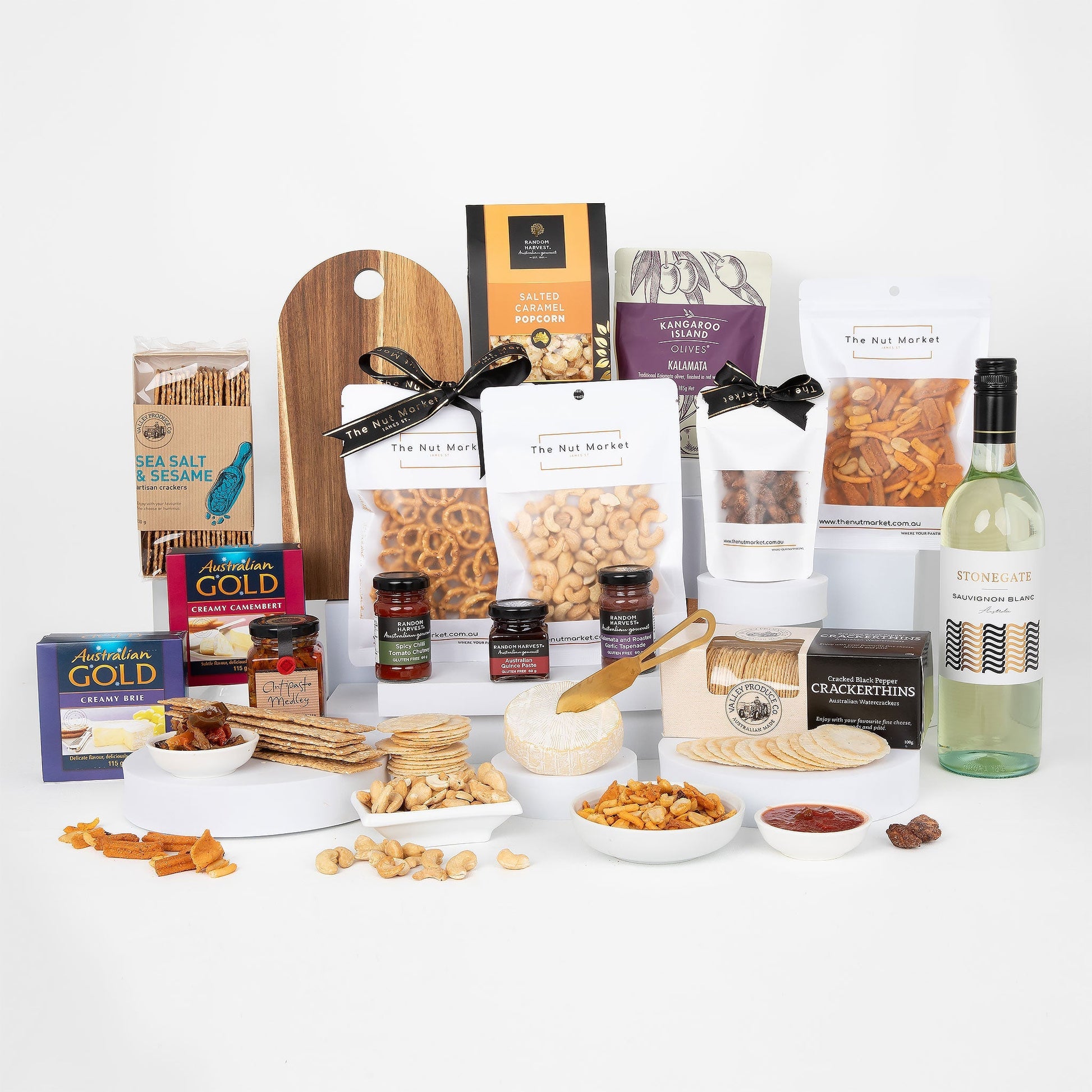 Assorted food items including nuts, cheese, and wine on a white background