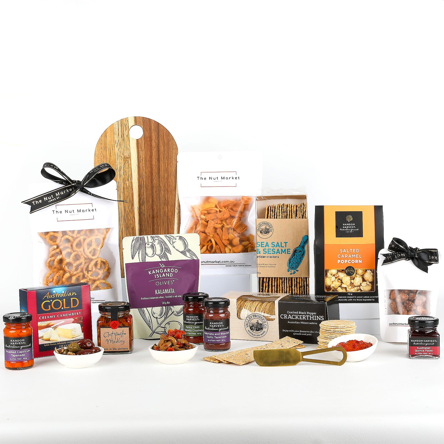 Assorted food products including snacks, condiments, and a cutting board on a white background