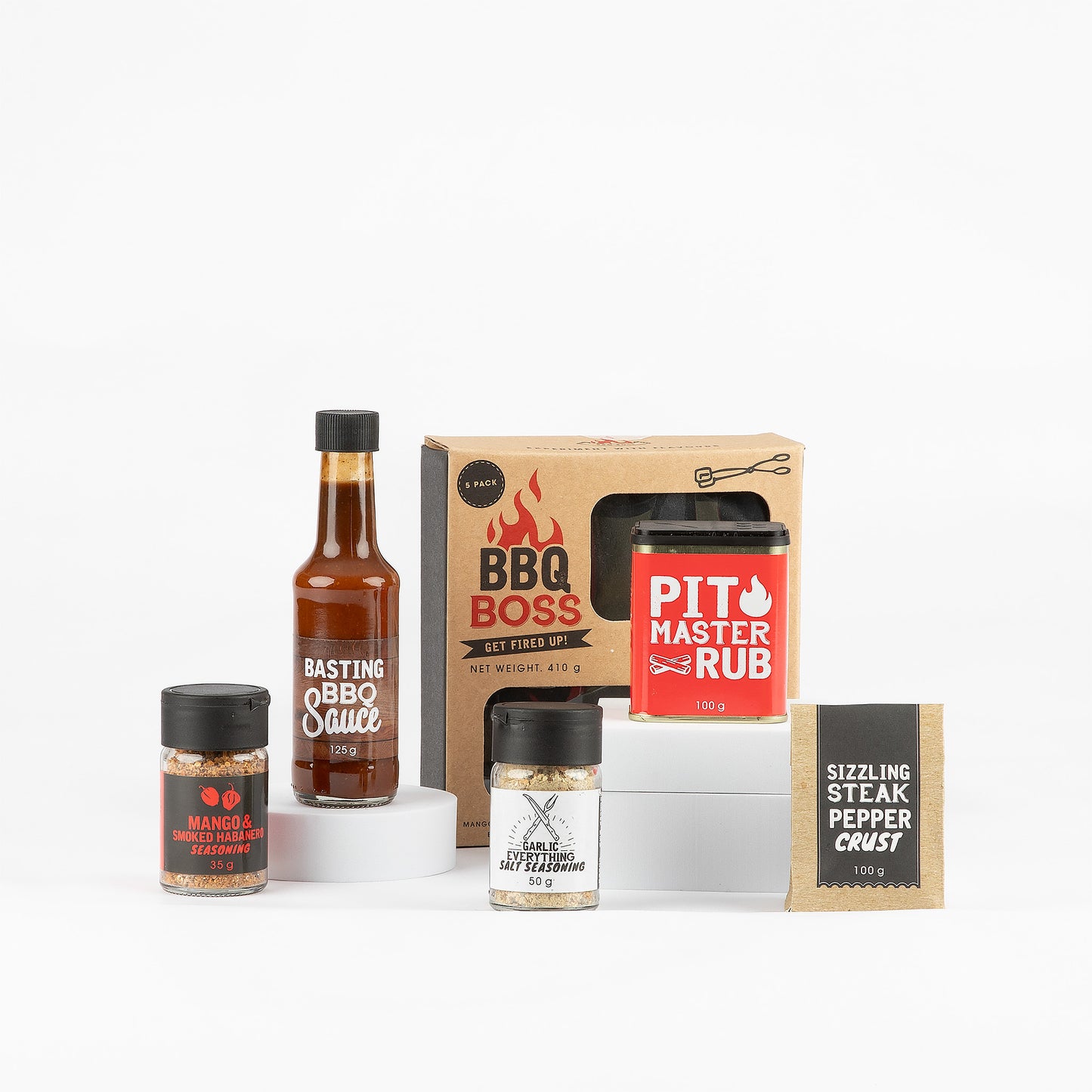 Collection of barbecue seasonings, rubs and sauce on a white background.