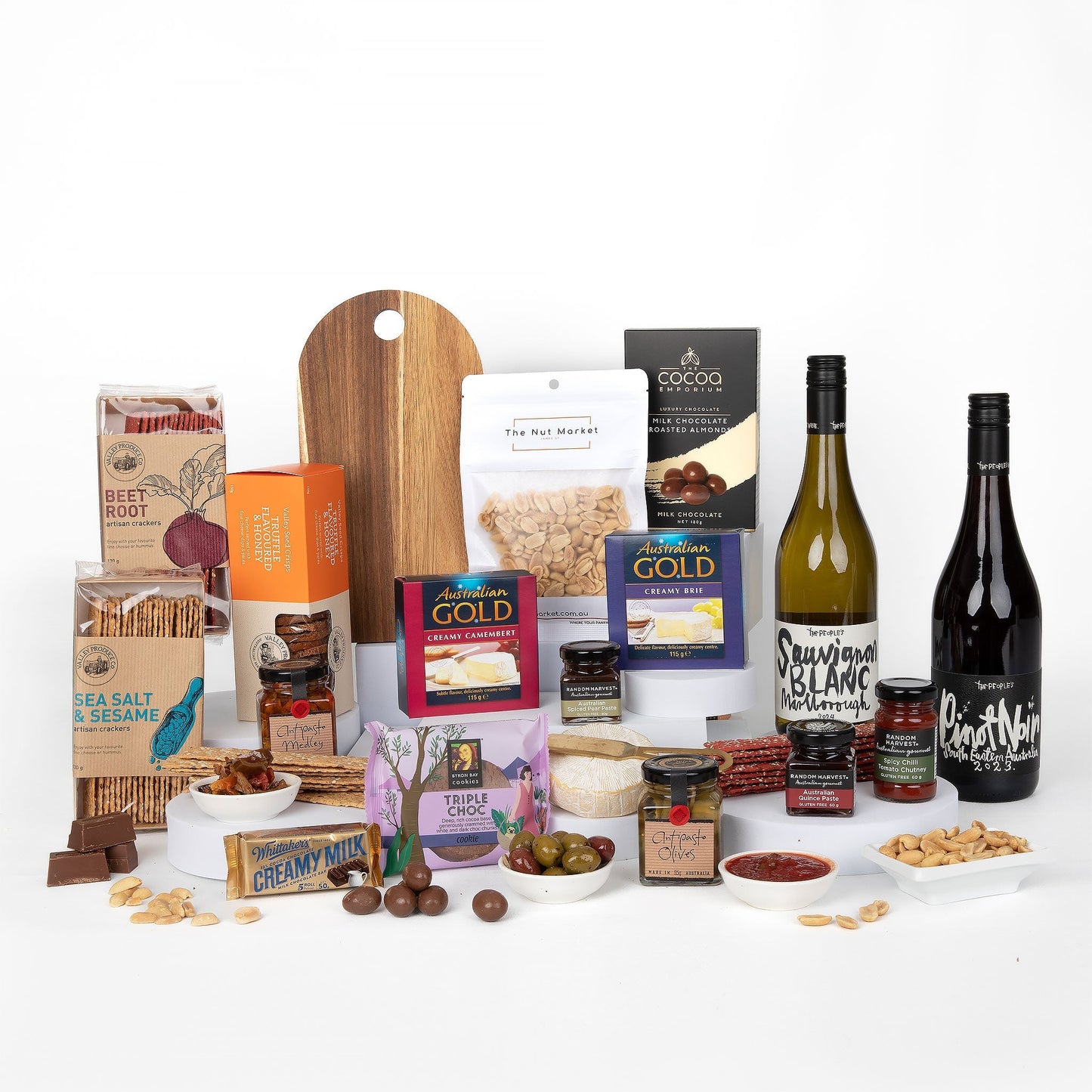 Assorted food products including wines, cheese, and snacks on a white background