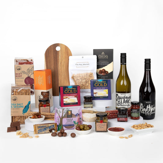 Assorted food products including wines, cheese, and snacks on a white background