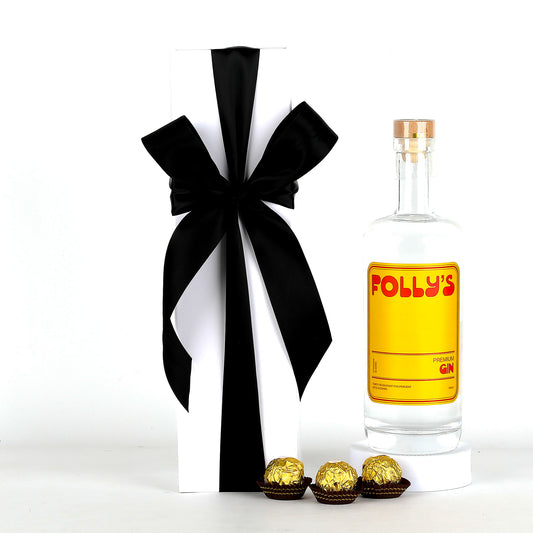 Bottle of Folly's gin with a black bow and chocolates on a white background