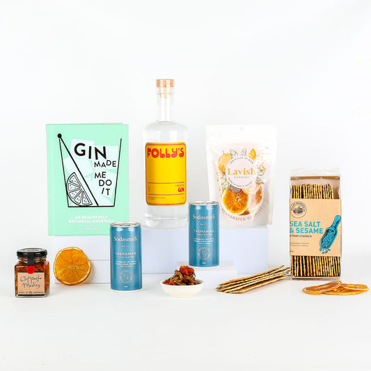 Folly’s Premium Gin, tonic water, recipe book & treats on a white background