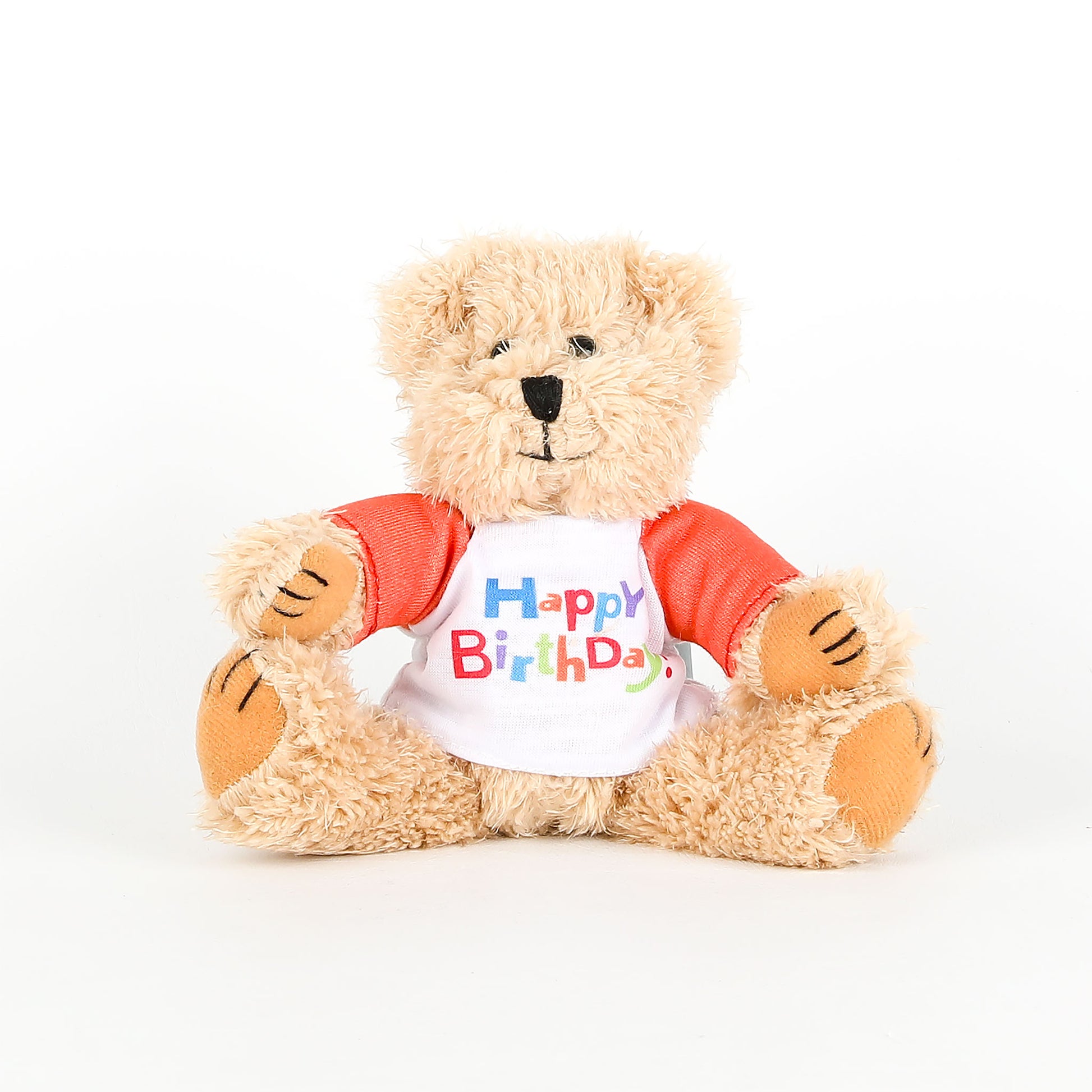 Plush teddy bear wearing a 'Happy Birthday' shirt on a white background