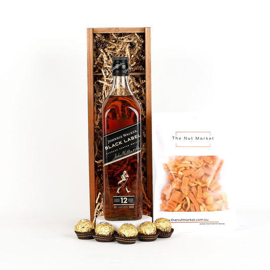 Johnnie Walker Black Label whisky bottle in a wooden box with Ferrero Rocher chocolates and a packet from The Nut Market.