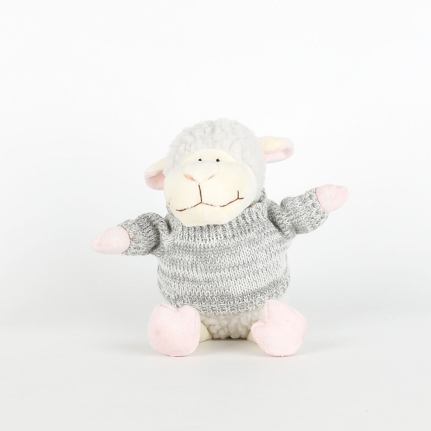 Plush toy sheep with a knitted sweater on a white background