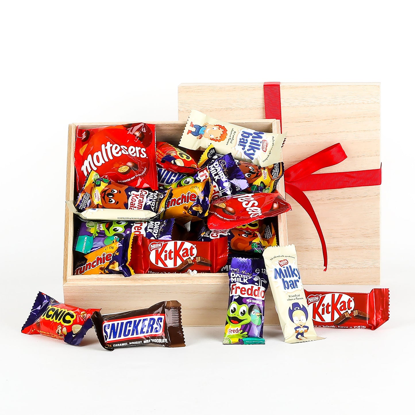 Assorted chocolate bars in a wooden gift box with a red ribbon on a white background