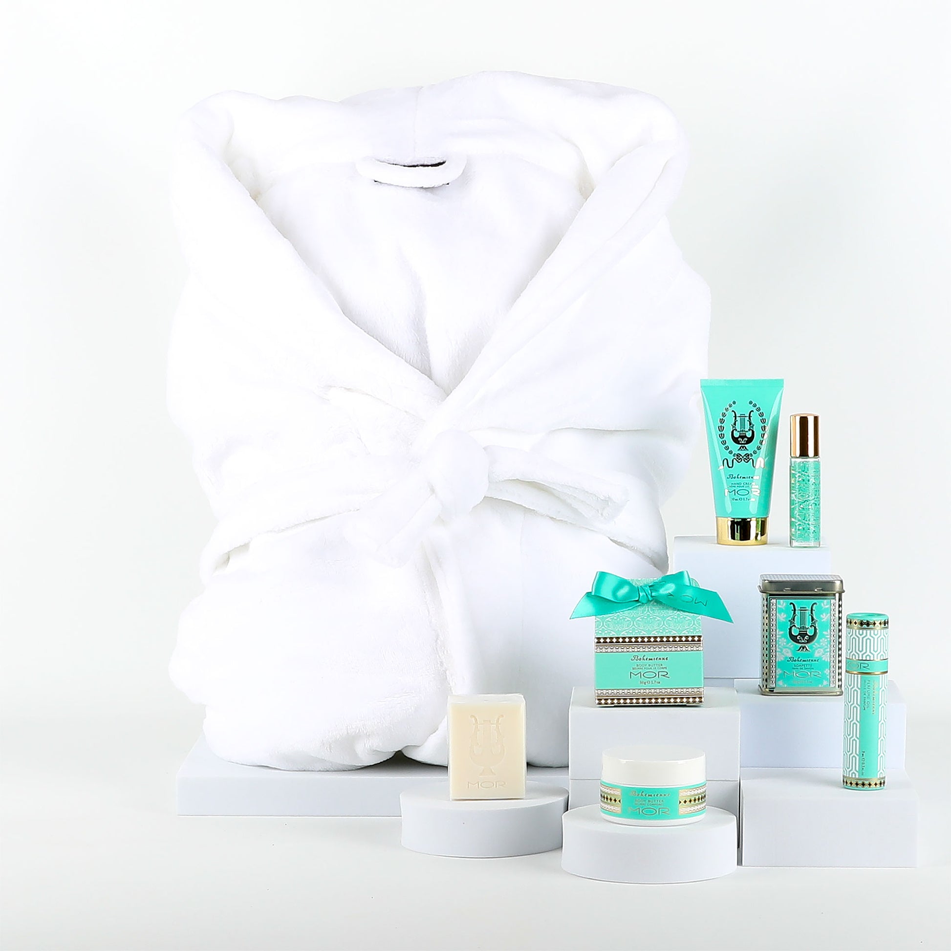 Collection of MOR skincare products with a white robe on a white background
