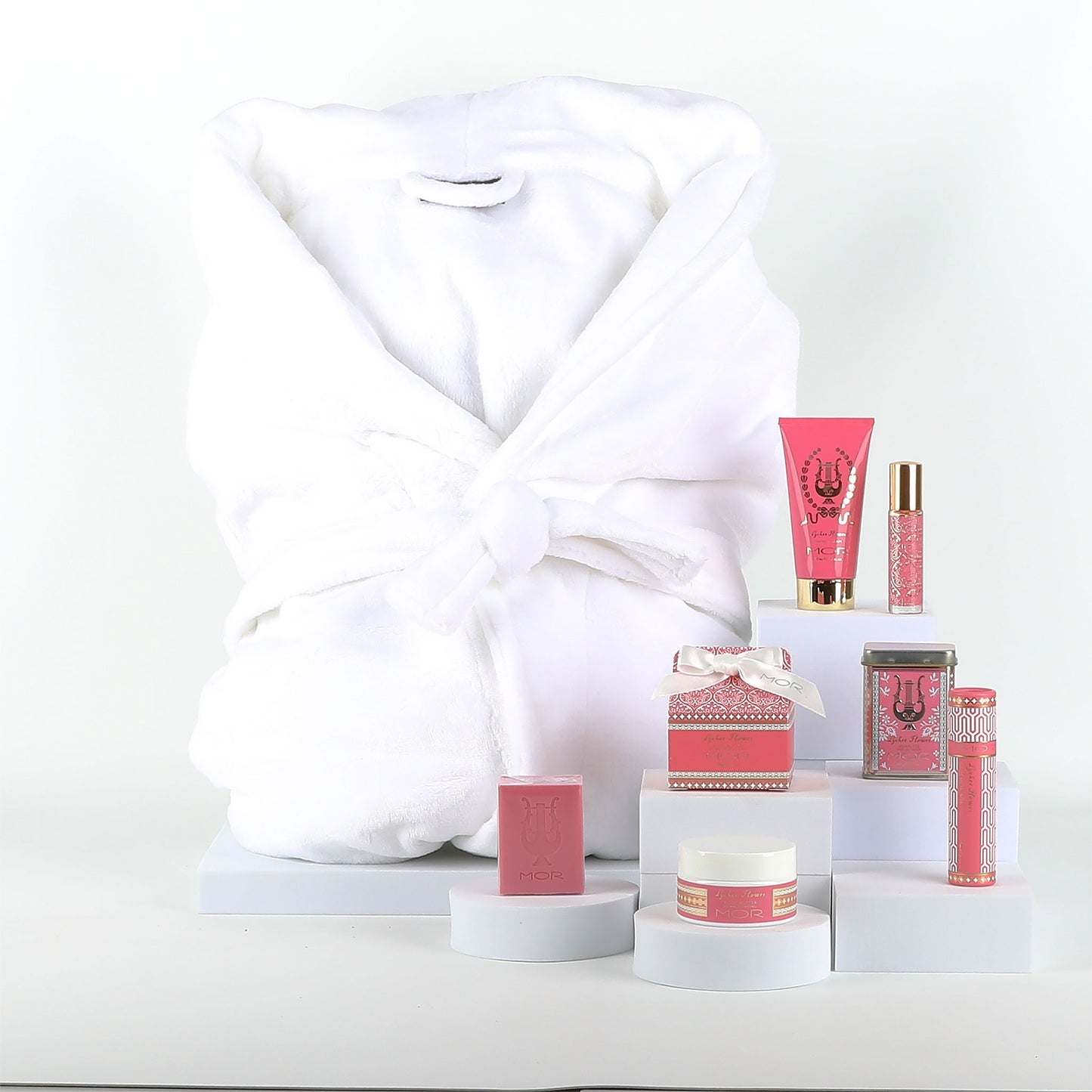 Cosmetic products with a white robe on a white background