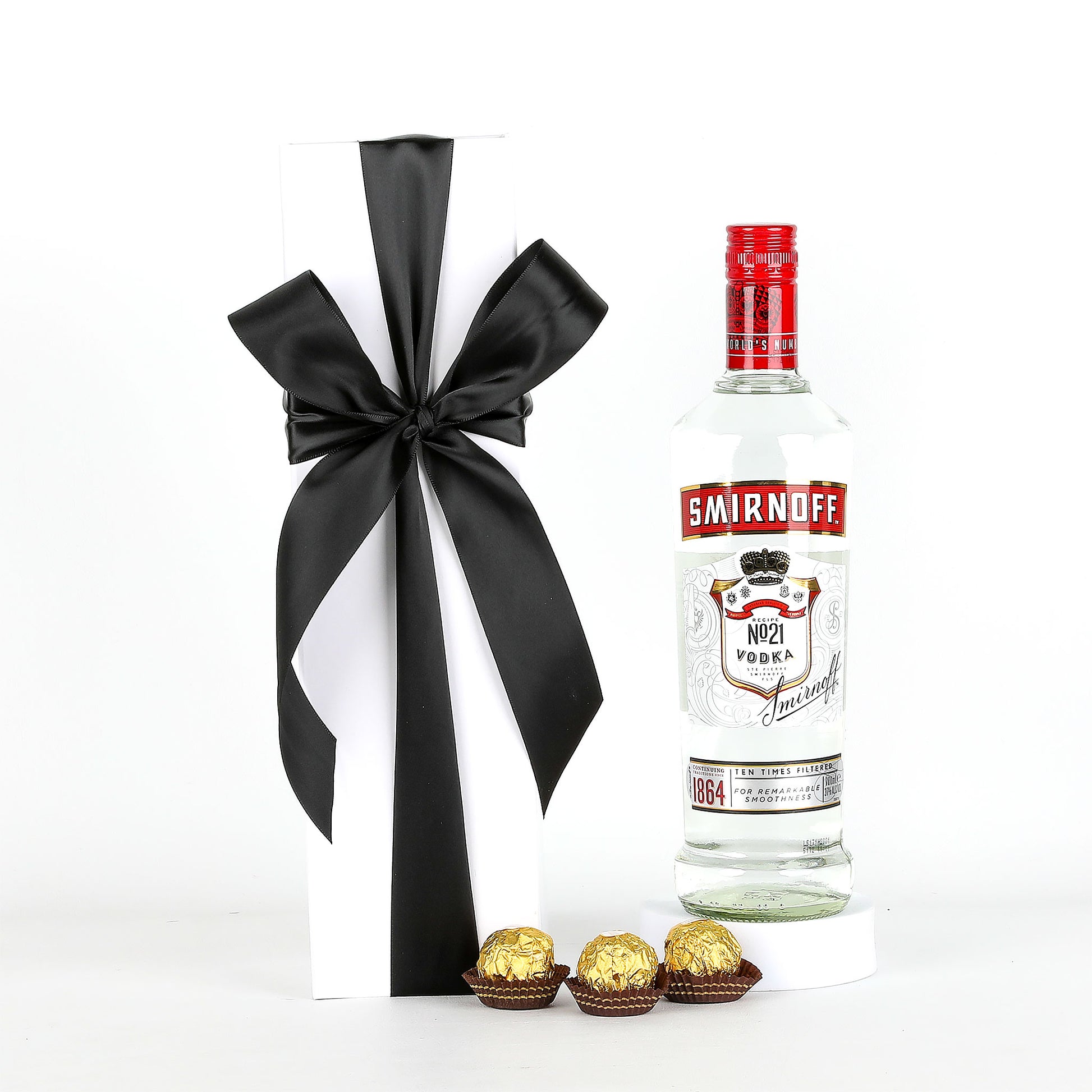 Smirnoff vodka bottle with a black ribbon and Ferrero Rocher chocolates on a white background