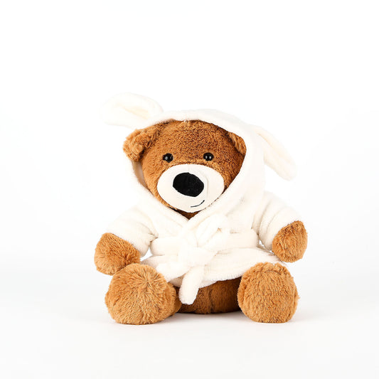 Brown teddy bear wearing a white robe on a white background