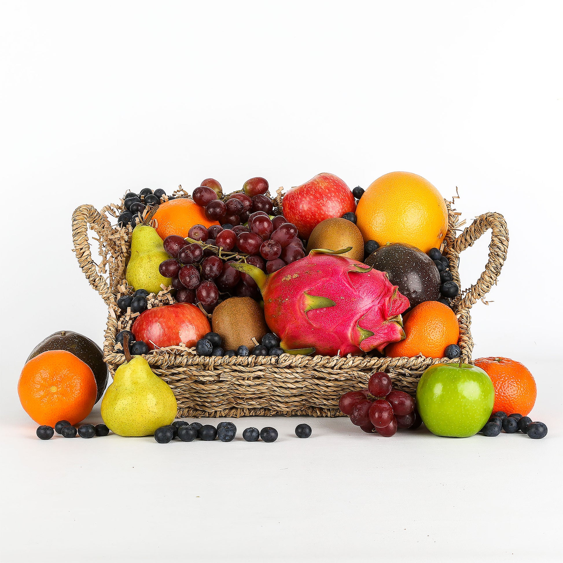 Basket of assorted fruits on a white background