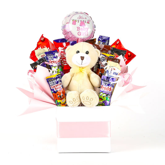 Gift basket with teddy bear, chocolate, and balloon on a white background