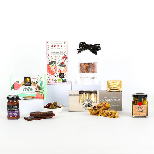 Vegan hamper filled with premium plant-based delights. Featuring savoury crackers, gourmet nuts, artisan chocolate, fruity jam, and other delicious vegan treats.